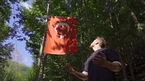 Young-muslim-praying-looking-at-Turkish-flag.-Slow-Motion.